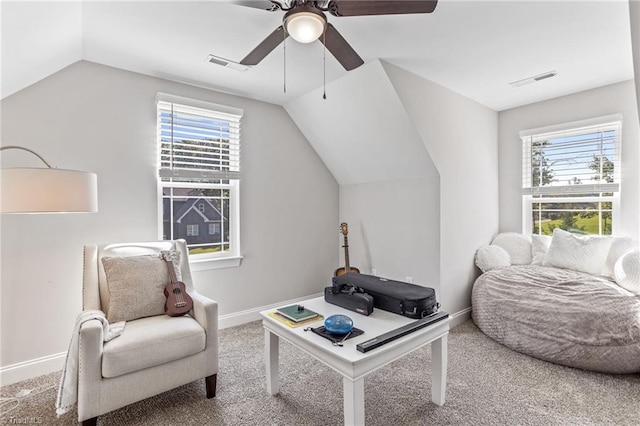 living area featuring carpet floors, ceiling fan, vaulted ceiling, and a wealth of natural light