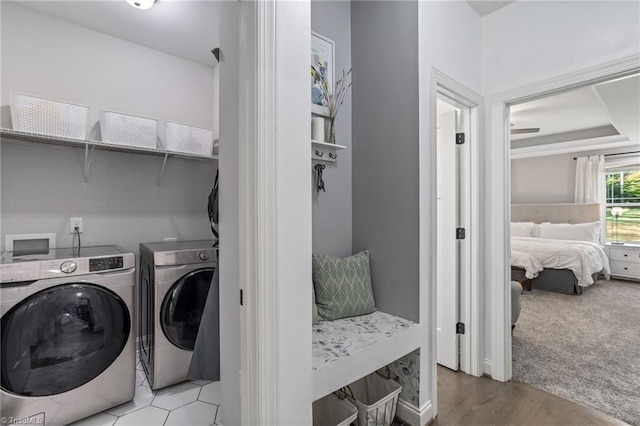 clothes washing area featuring washing machine and dryer and light carpet