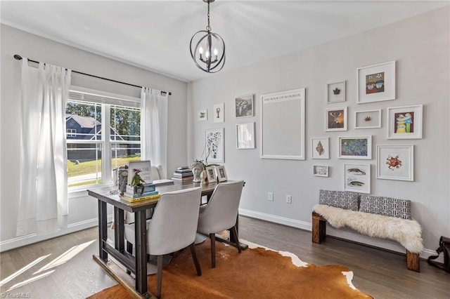 dining space with a notable chandelier and dark hardwood / wood-style flooring