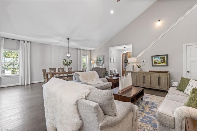 living room with high vaulted ceiling, a wealth of natural light, and dark hardwood / wood-style floors