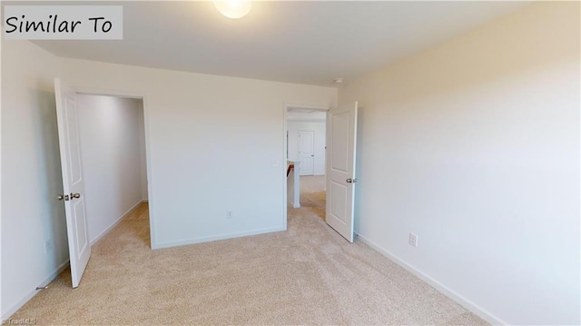 unfurnished bedroom with baseboards and light colored carpet