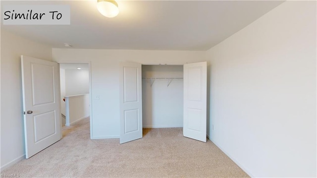 unfurnished bedroom with a closet and light carpet