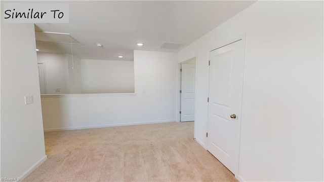 carpeted spare room with visible vents, recessed lighting, attic access, and baseboards