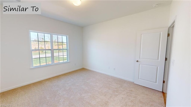 unfurnished room with light carpet and baseboards