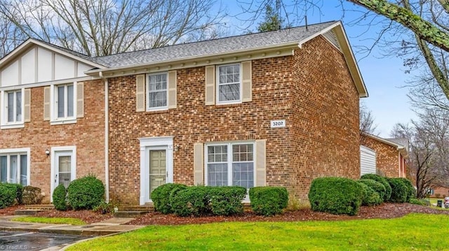 colonial home with a front lawn