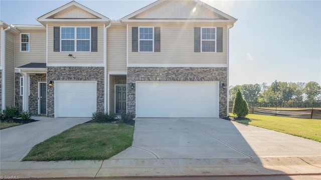 view of front facade with a garage and a front lawn