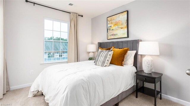 bedroom featuring light colored carpet