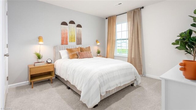 bedroom with light colored carpet