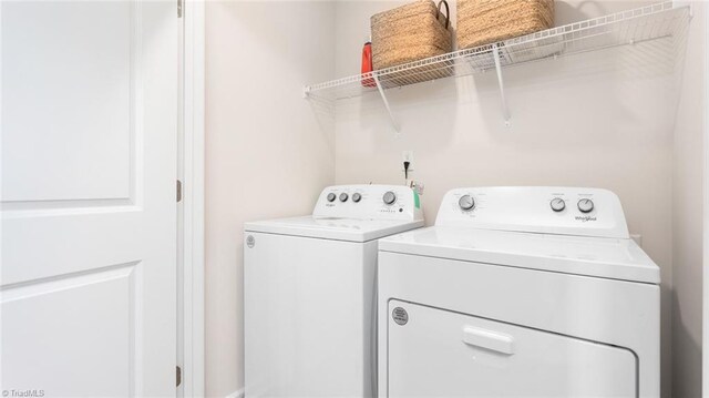 clothes washing area with independent washer and dryer