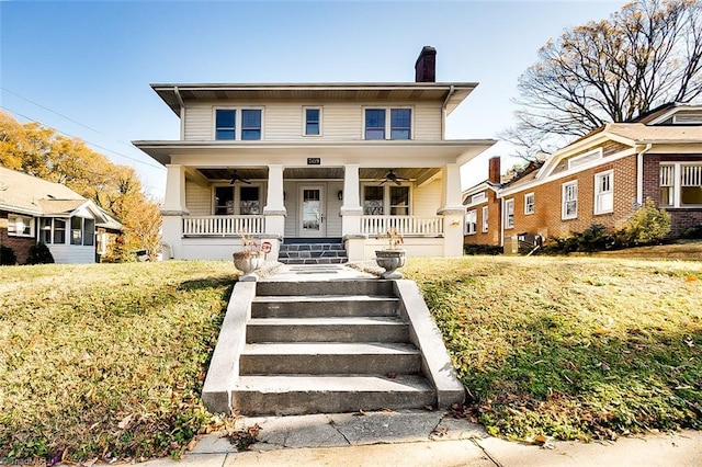 bungalow-style home featuring covered porch and a front yard