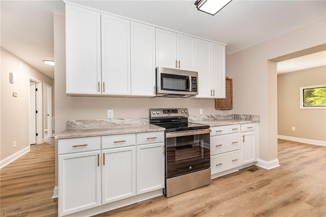 4353 Valley View Rd, Thomasville, NC 27370 - kitchen featuring stainless steel appliances, white cabinetry, baseboards, and light wood-type flooring