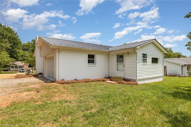 4353 Valley View Rd, Thomasville, NC 27370 - rear view of property featuring a lawn, metal roof, entry steps, and a garage