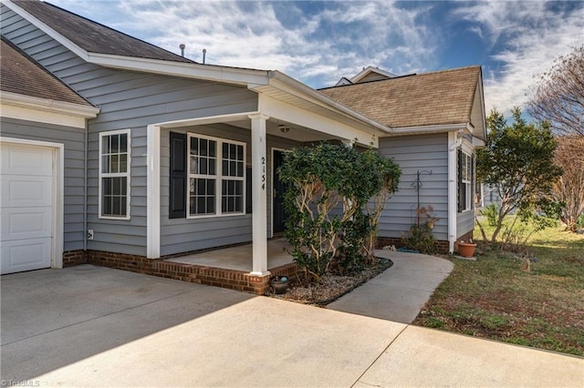 exterior space with a garage and covered porch