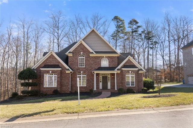 view of front of property featuring a garage and a front lawn