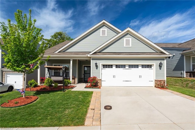 craftsman-style house with covered porch, a garage, and a front yard