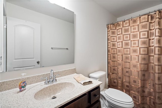 bathroom featuring toilet and vanity