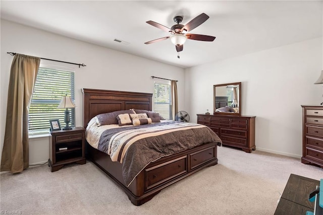 bedroom featuring light carpet and ceiling fan