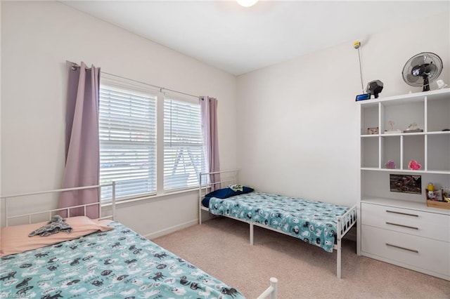 bedroom featuring light carpet