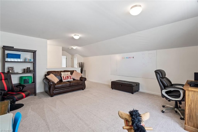 carpeted home office with vaulted ceiling