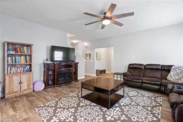 living room with hardwood / wood-style floors and ceiling fan