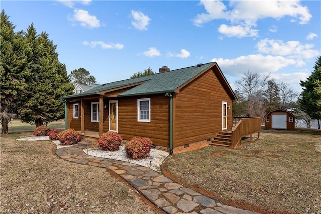 view of side of property featuring a storage shed, a lawn, and a garage