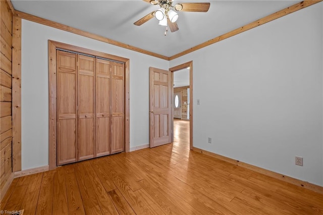 unfurnished bedroom with light hardwood / wood-style flooring, a closet, and ceiling fan