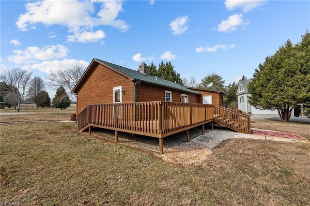 back of house featuring a yard and a deck