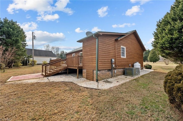 view of home's exterior featuring central AC unit, a deck, and a lawn