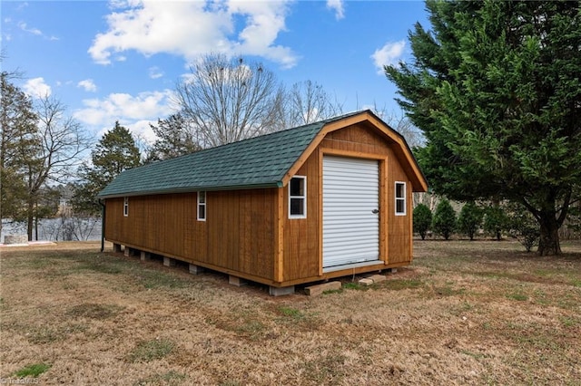 view of outbuilding featuring a lawn