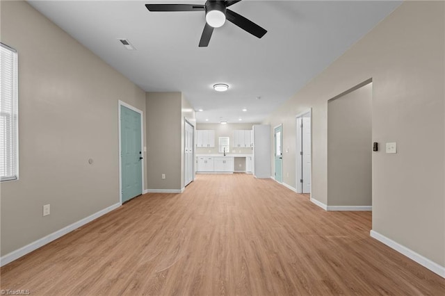 unfurnished living room with ceiling fan and light hardwood / wood-style floors