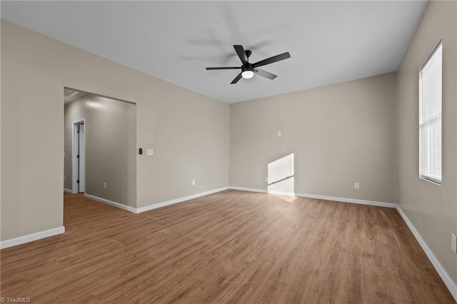 spare room with ceiling fan, light hardwood / wood-style floors, and a wealth of natural light