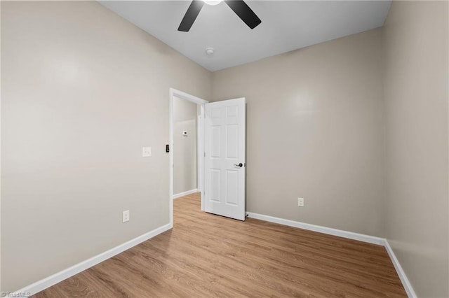 spare room with ceiling fan and light wood-type flooring