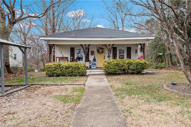 bungalow with a porch and a front lawn