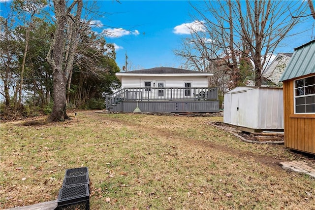 view of yard featuring a storage unit and a deck