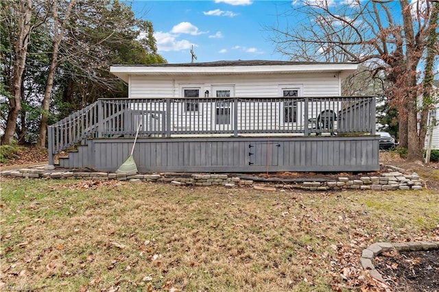 back of property featuring a lawn and a wooden deck