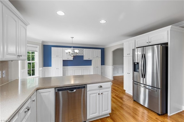 5119 Spiral Wood Dr, Clemmons, NC 27012 - kitchen featuring stainless steel appliances, a peninsula, white cabinetry, a chandelier, and arched walkways