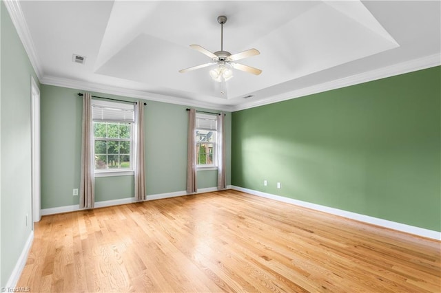5119 Spiral Wood Dr, Clemmons, NC 27012 - empty room featuring light wood-type flooring, crown molding, a raised ceiling, and a ceiling fan