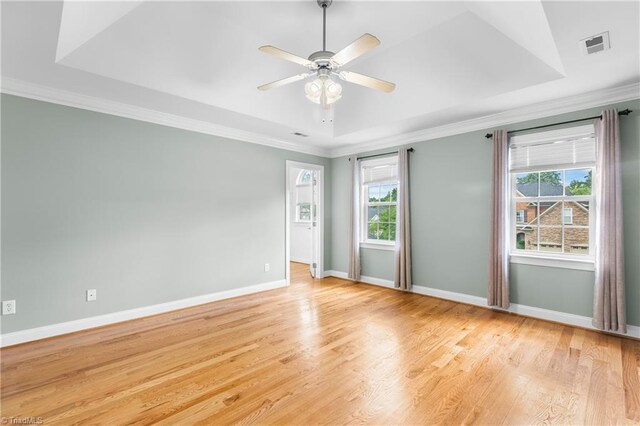 5119 Spiral Wood Dr, Clemmons, NC 27012 - spare room with crown molding, light wood-type flooring, a raised ceiling, and a ceiling fan