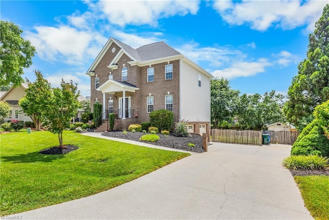 5119 Spiral Wood Dr, Clemmons, NC 27012 - colonial house featuring concrete driveway, brick siding, and an attached garage