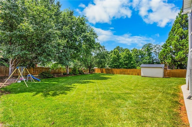 5119 Spiral Wood Dr, Clemmons, NC 27012 - fenced backyard featuring a storage shed and a playground