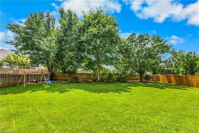 5119 Spiral Wood Dr, Clemmons, NC 27012 - fenced backyard featuring a playground
