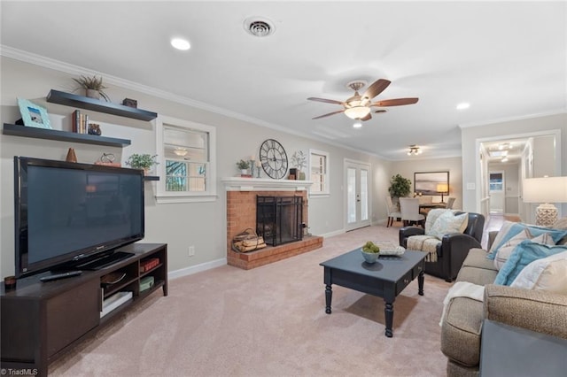 living room with ceiling fan, a fireplace, light colored carpet, and ornamental molding