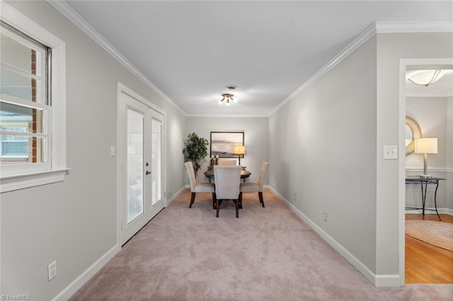 interior space with light carpet, french doors, and ornamental molding