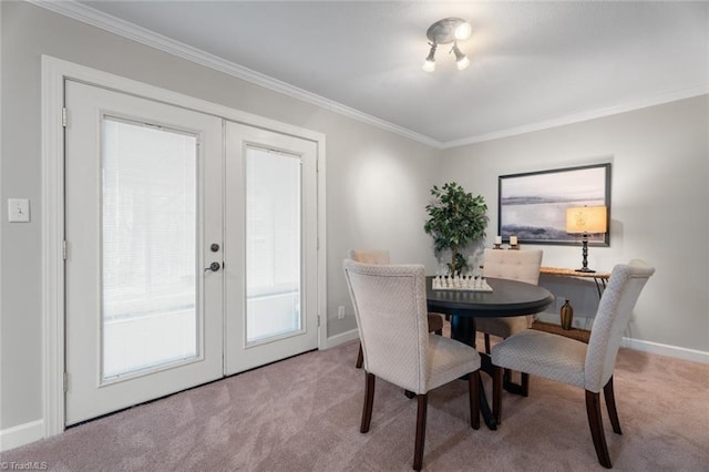 carpeted dining room with crown molding and french doors