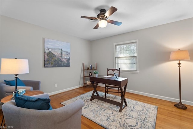 home office with hardwood / wood-style floors and ceiling fan