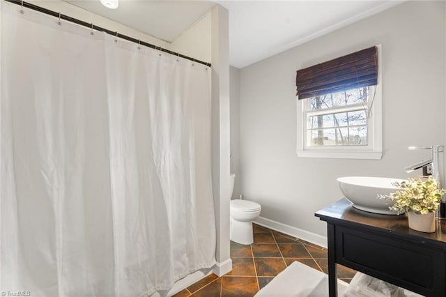 bathroom featuring tile patterned flooring, vanity, and toilet