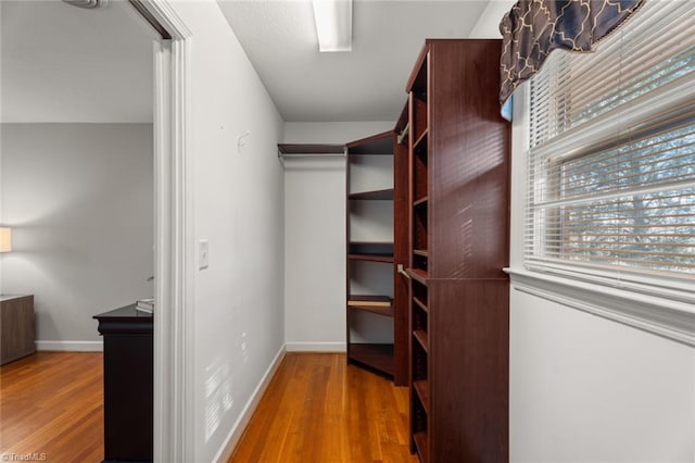 spacious closet featuring hardwood / wood-style floors