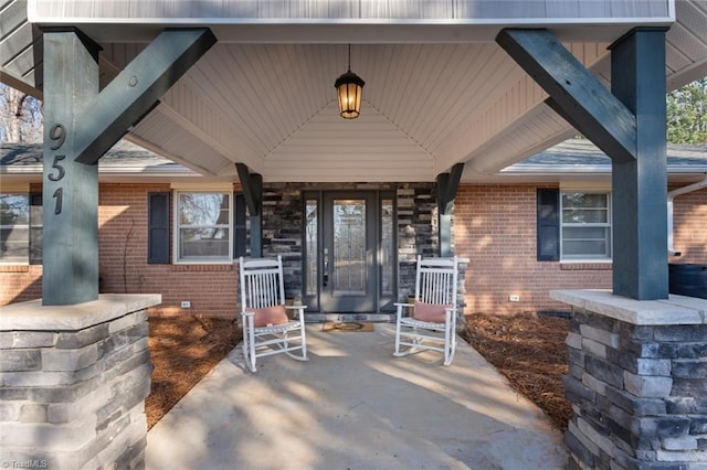 view of exterior entry featuring covered porch