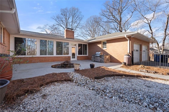 back of property featuring a fire pit and a patio area