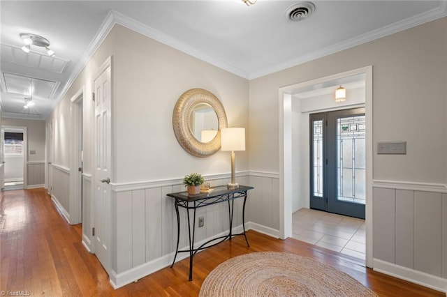 entrance foyer with light hardwood / wood-style floors and ornamental molding